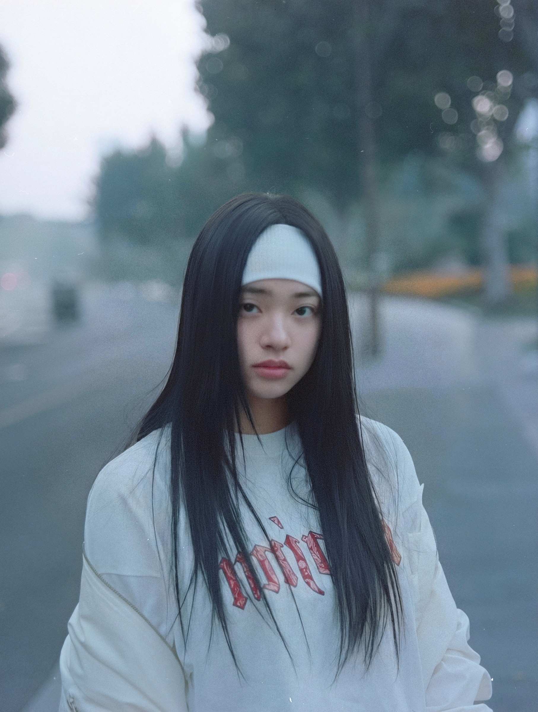 Close portrait of a woman with a white headband on a misty bridge