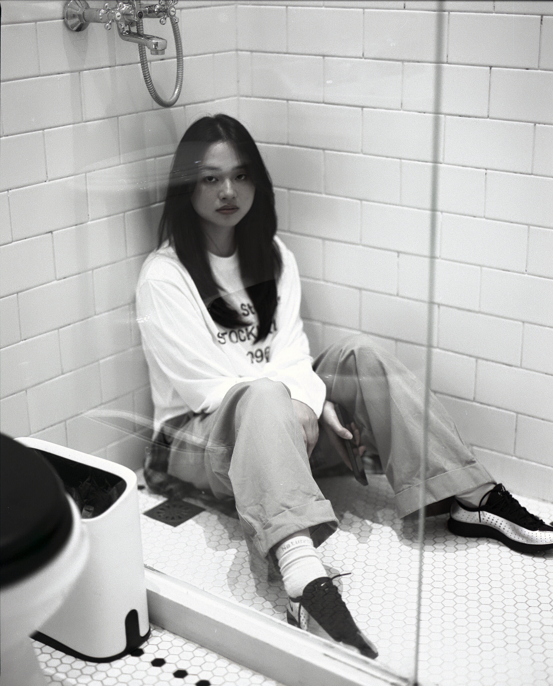 Black-and-white portrait in a tiled room