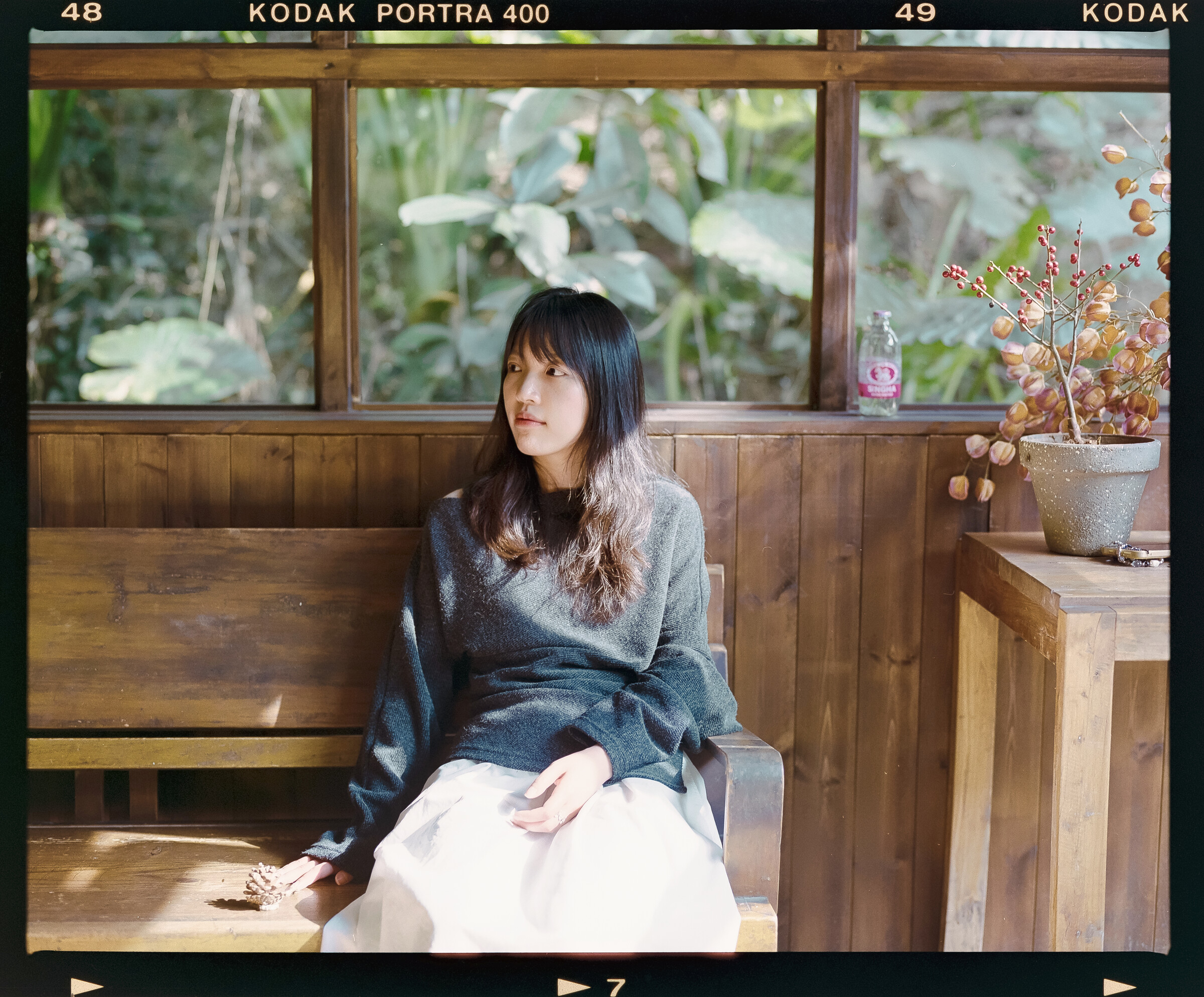 Portrait beside a wooden window